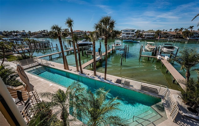 dock area with a water view and a community pool