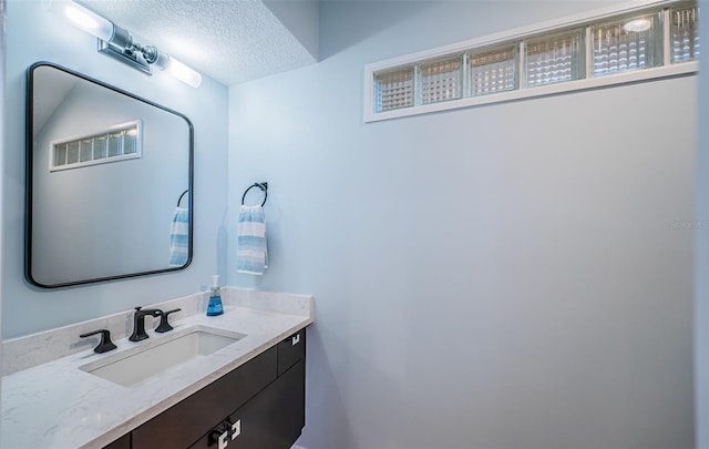 bathroom featuring vanity and a textured ceiling