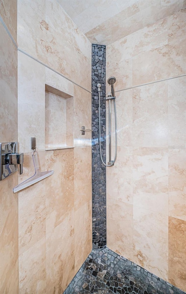 bathroom with a tile shower