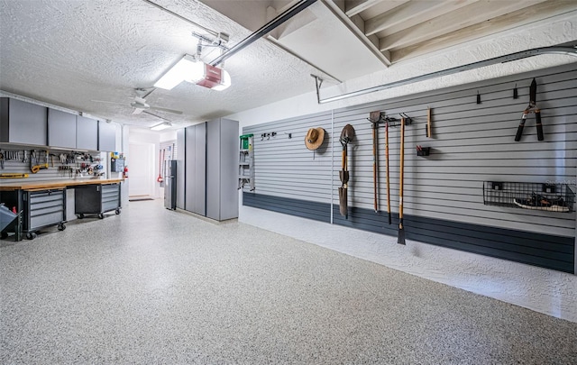 garage featuring a garage door opener and a workshop area