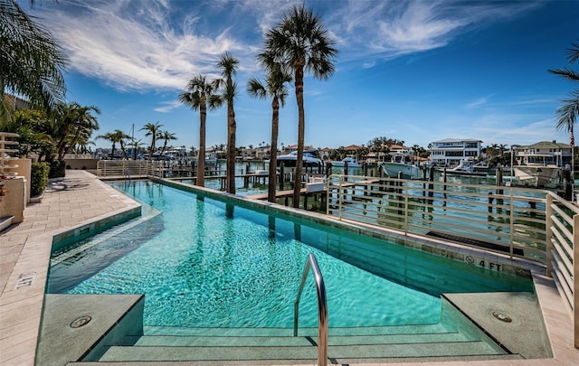 view of swimming pool with a water view