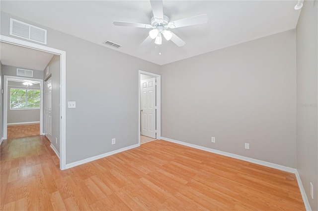 empty room with light hardwood / wood-style flooring and ceiling fan