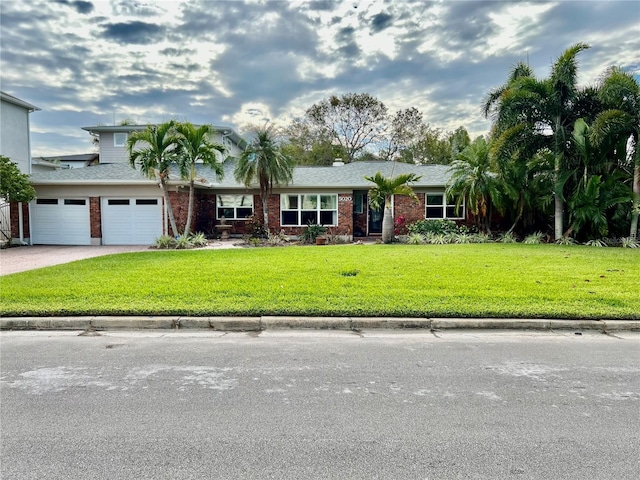 view of front of home with a garage and a front yard