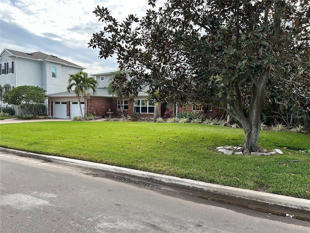 view of front of house featuring a garage and a front lawn