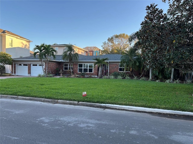 view of front of property with a front lawn and a garage