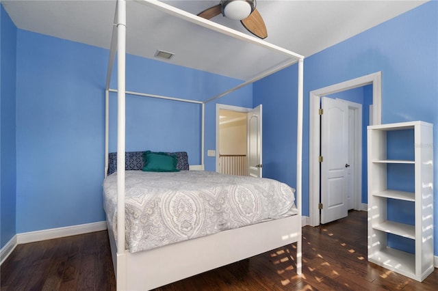 bedroom with dark hardwood / wood-style floors