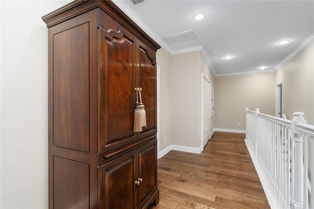 hallway featuring dark wood-type flooring and ornamental molding