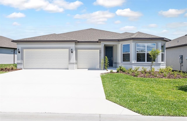 prairie-style house featuring an attached garage, driveway, a front lawn, and stucco siding