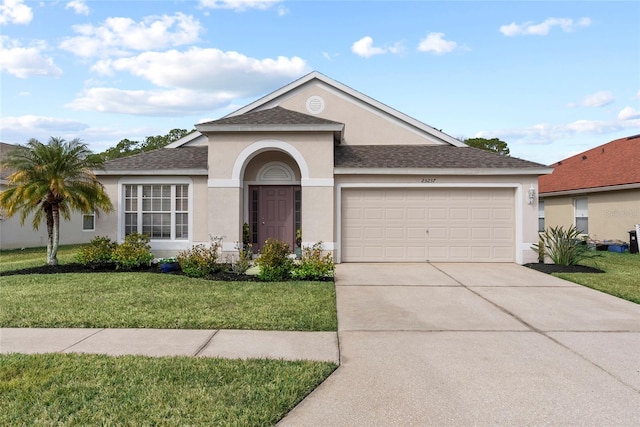 single story home with a garage and a front yard