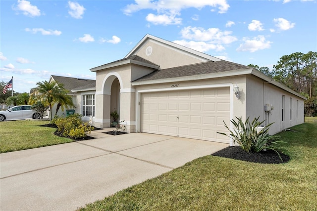 ranch-style home featuring a garage and a front lawn