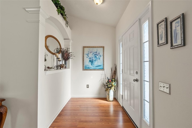 foyer featuring vaulted ceiling and light hardwood / wood-style floors