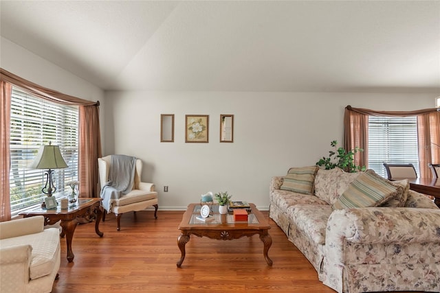 living room with lofted ceiling and light wood-type flooring