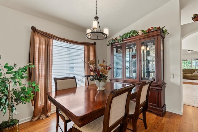 dining space featuring light hardwood / wood-style flooring and vaulted ceiling