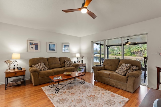 living room featuring ceiling fan and light hardwood / wood-style floors