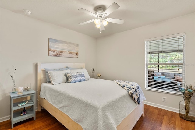 bedroom with ceiling fan and dark hardwood / wood-style floors