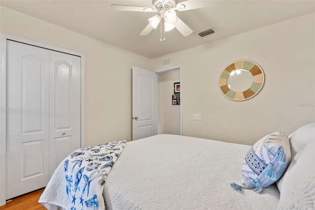 bedroom with hardwood / wood-style flooring, a closet, and ceiling fan