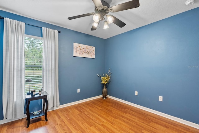 unfurnished room with ceiling fan and light wood-type flooring