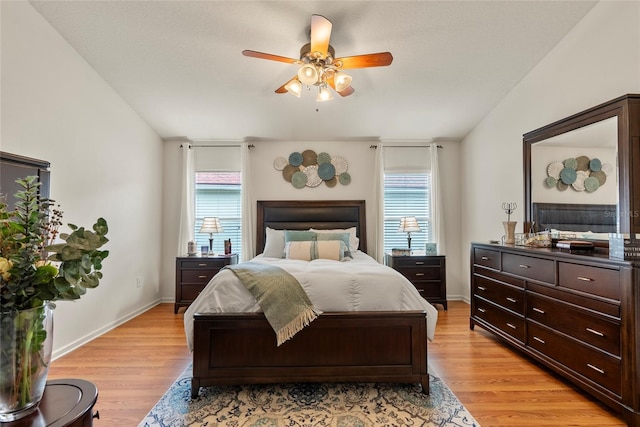 bedroom with lofted ceiling, ceiling fan, and light hardwood / wood-style flooring