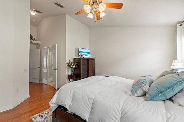 bedroom featuring ceiling fan, high vaulted ceiling, and light hardwood / wood-style flooring