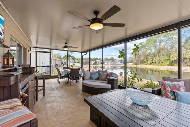 sunroom / solarium featuring a water view and a wealth of natural light