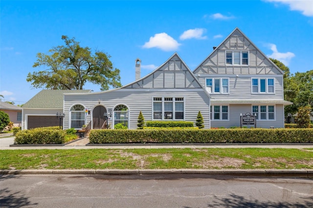 tudor-style house with a garage