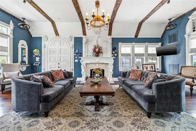 living room featuring a notable chandelier, a fireplace, lofted ceiling with beams, and dark wood-type flooring