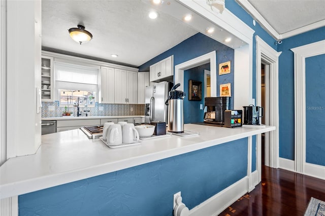 kitchen with white cabinets, kitchen peninsula, sink, and stainless steel appliances