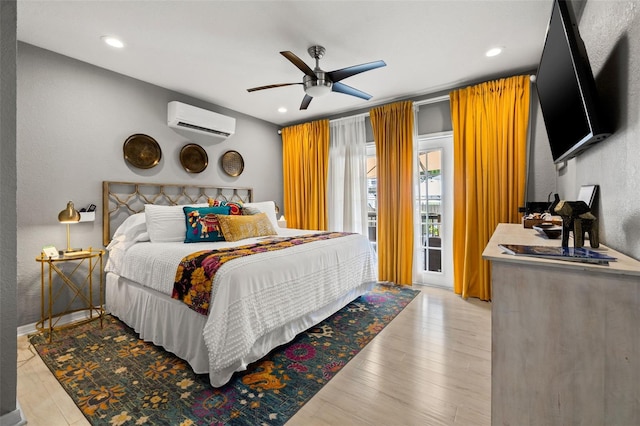 bedroom featuring access to exterior, light wood-type flooring, an AC wall unit, and ceiling fan