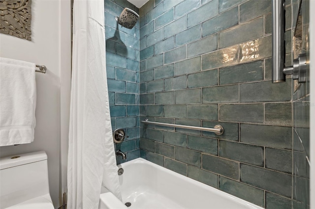 bathroom featuring shower / tub combo and toilet