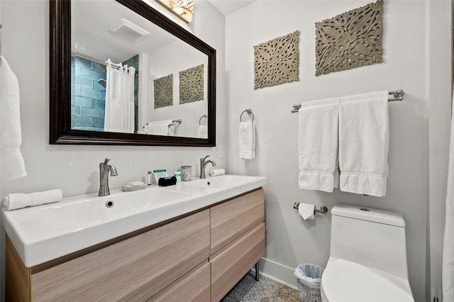 bathroom featuring vanity and toilet