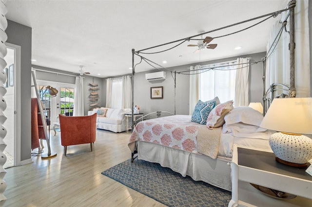 bedroom featuring an AC wall unit and light hardwood / wood-style floors