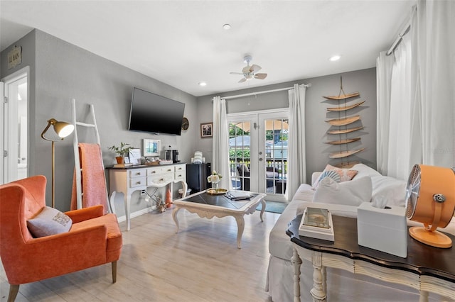 living room with ceiling fan, french doors, and light wood-type flooring