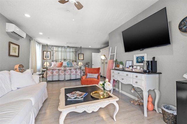 bedroom featuring light wood-type flooring, a wall mounted AC, and ceiling fan