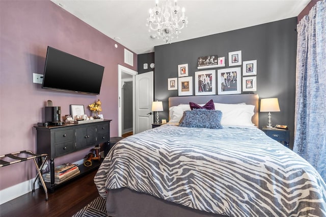 bedroom featuring dark hardwood / wood-style flooring and an inviting chandelier