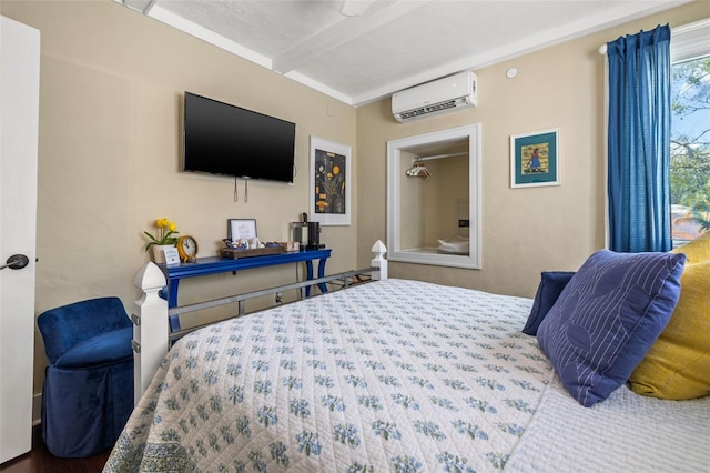 bedroom featuring beam ceiling and a wall mounted air conditioner