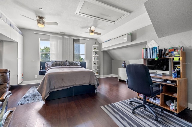 bedroom with a textured ceiling, dark wood-type flooring, ceiling fan, and lofted ceiling