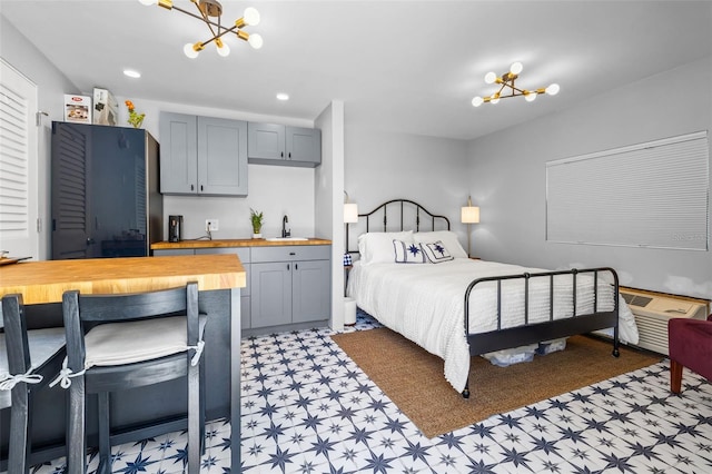 bedroom featuring sink and an inviting chandelier