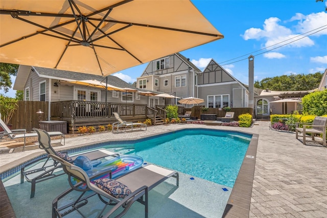 view of pool featuring a patio area and a wooden deck