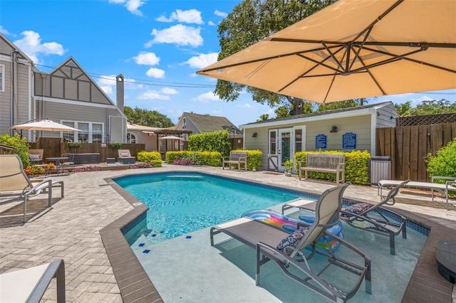 view of swimming pool with a patio area and an outbuilding