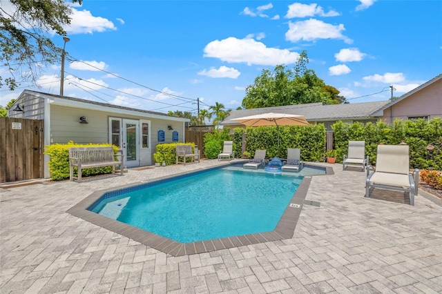 view of swimming pool with a patio and french doors