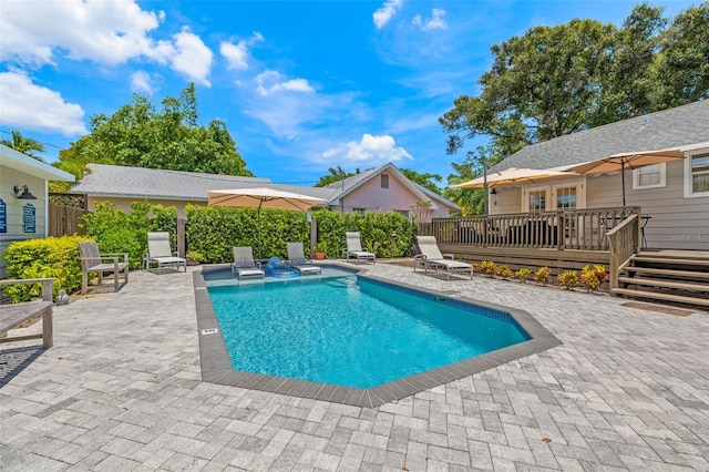 view of pool with a patio and a deck