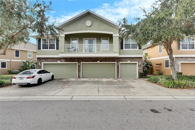 view of front of home featuring a balcony and a garage