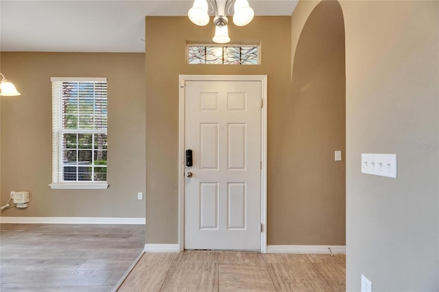 foyer featuring light hardwood / wood-style flooring and an inviting chandelier