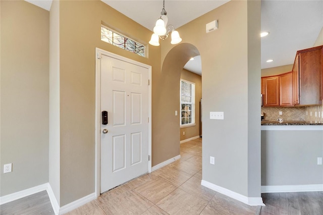 entryway with a notable chandelier