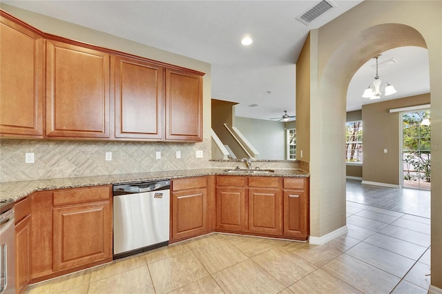 kitchen featuring light stone countertops, stainless steel dishwasher, ceiling fan with notable chandelier, sink, and light tile patterned flooring