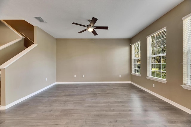 unfurnished room featuring hardwood / wood-style floors and ceiling fan