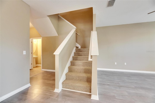 staircase featuring wood-type flooring