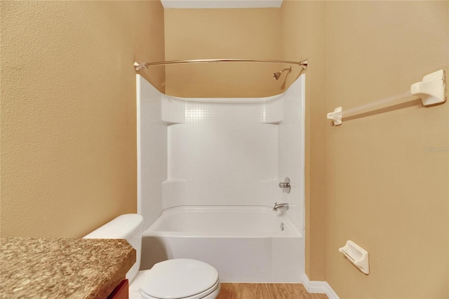 full bathroom featuring bathtub / shower combination, vanity, hardwood / wood-style flooring, and toilet