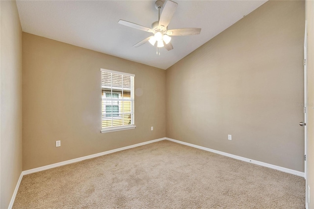 carpeted spare room with ceiling fan