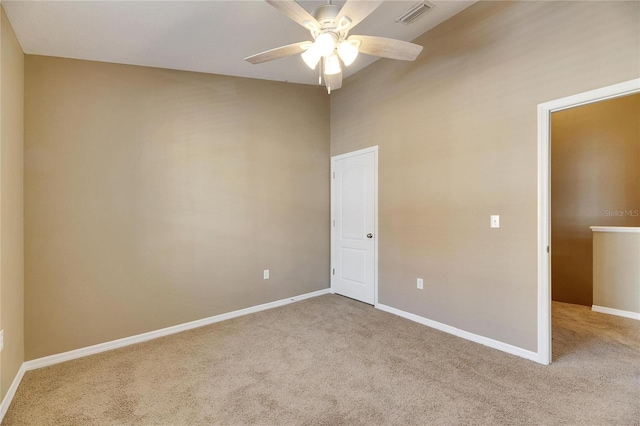 unfurnished room with ceiling fan, light carpet, and high vaulted ceiling